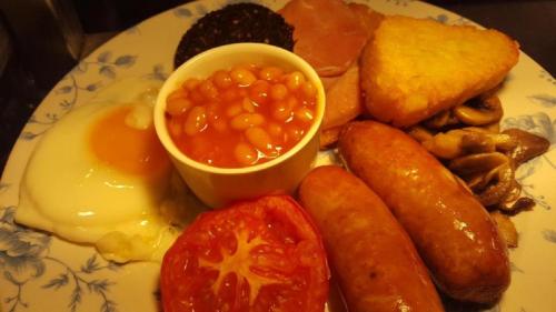 a plate of food with eggs sausage beans and bread at The Dolphin Hotel in Whitby