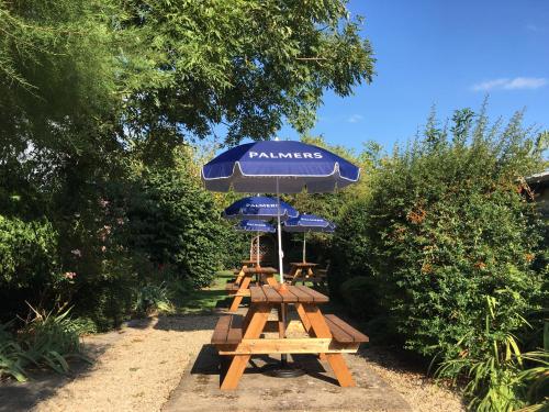 a group of picnic tables with umbrellas at Phelips Arms in Yeovil