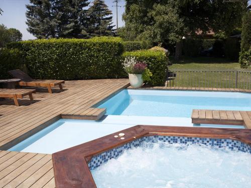 a swimming pool with a wooden deck and a wooden deck at Le Domaine du Plantier in Saint-Hilaire-de-la-Côte