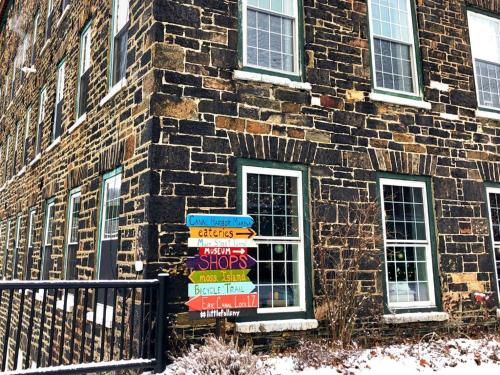 a brick building with a bunch of signs on it at The Inn at Stone Mill in Little Falls