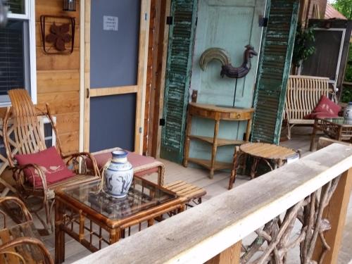 a porch with a table and chairs on a house at The Iris Garden Downtown Cottages and Suites in Nashville