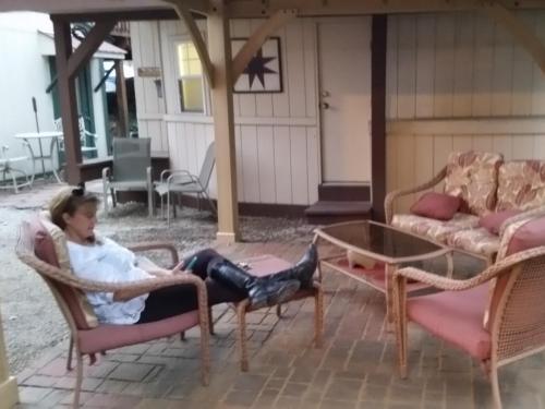 a woman sitting in a chair on a patio at The Iris Garden Downtown Cottages and Suites in Nashville