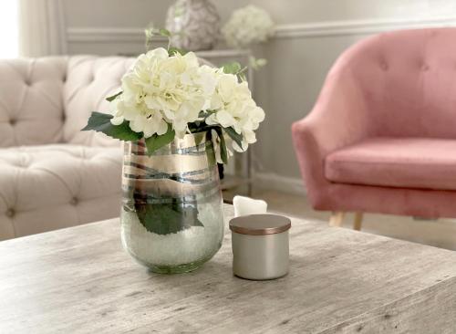 a vase with white flowers sitting on a table at Price & Weeks - Heart of Bath in Bath