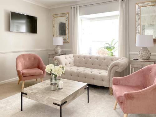 a living room with a couch and two chairs at Price & Weeks - Heart of Bath in Bath