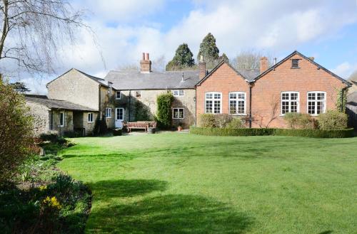 a large brick house with a large yard at The Old School in Bicester