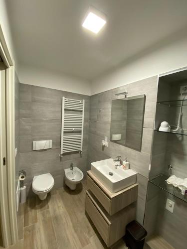 a bathroom with a sink and a toilet and a mirror at Room 26 - B&B Altamura in Altamura