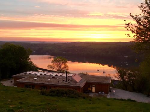 a house on a hill with a view of a lake at The Sanctuary Cornwall in Golant