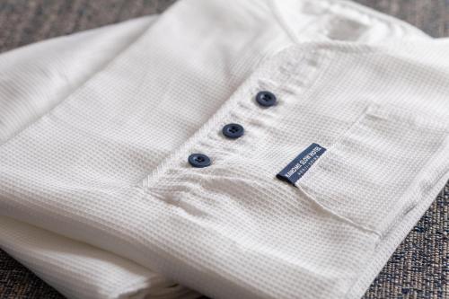 a close up of a white shirt with blue buttons at KAMOME SLOW HOTEL in Awaji
