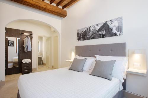 a bedroom with a large white bed in a room at B&B il Barbero in Siena