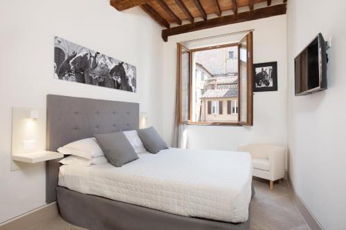 a bedroom with a large bed and a window at B&B il Barbero in Siena