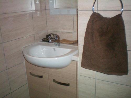 a bathroom with a sink and a bag on the wall at 103 ELEGANT 2 bed apartment with free Wifi, AC, pool & gym! in Larnaka