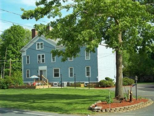 a blue house with a tree in front of it at Tin Brook Bed & Breakfast in Walden