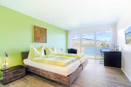 a bedroom with a large bed and a large window at Gasthof Fabriggli Wallbach CH in Wallbach