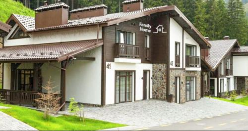a large house with a white and brown at Family Home in Bukovel