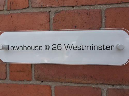 a sign on a brick wall with the words towswick o westminster at Townhouse PLUS @ Westminster Street Crewe in Crewe