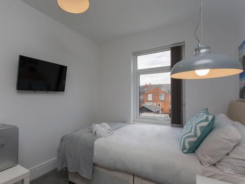 a bedroom with a bed and a window at Townhouse PLUS @ Westminster Street Crewe in Crewe