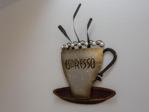 a cup of coffee hanging on a wall at Townhouse PLUS @ Westminster Street Crewe in Crewe