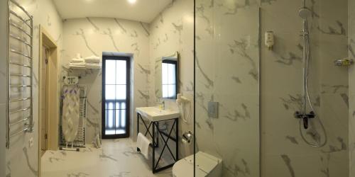 a bathroom with a shower and a toilet and a sink at Family Home in Bukovel