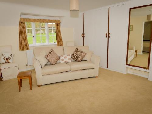 a living room with a couch and a mirror at Twyford Farm B&B in Haywards Heath