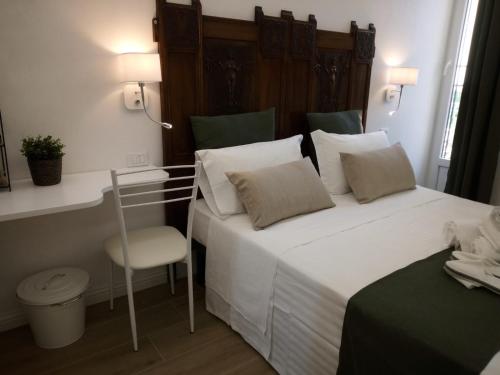 a bedroom with a white bed and a chair at Vittorio Veneto Private SPA in Sulmona