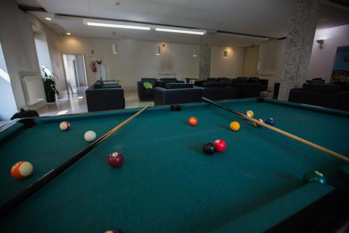 a billiard room with a pool table and balls at HI Guimaraes - Pousada de Juventude in Guimarães
