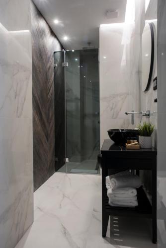 a bathroom with a shower and a sink at The Location Hotel in Belgrade