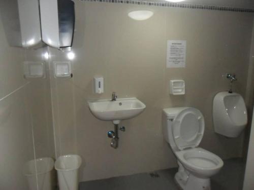 a bathroom with a toilet and a sink at BnT Inn in Mactan