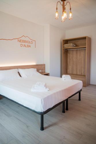 a bed in a room with a white mattress at Vino e Turismo in San Defedente di Cervasca