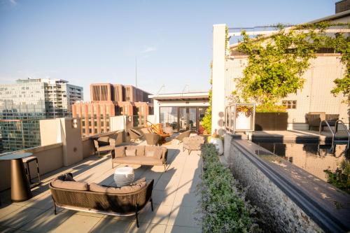 a rooftop patio with couches and tables on a building at The Windsor Suites Philadelphia in Philadelphia