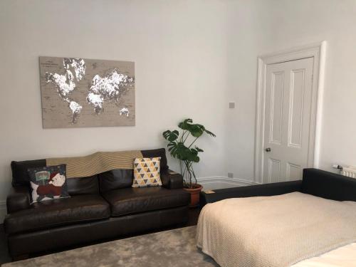 a living room with a couch and a bed at Sapphire House Sasco Apartments in Blackpool