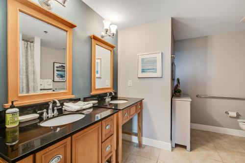 a bathroom with two sinks and a large mirror at Sterling Breeze 2 in Panama City Beach