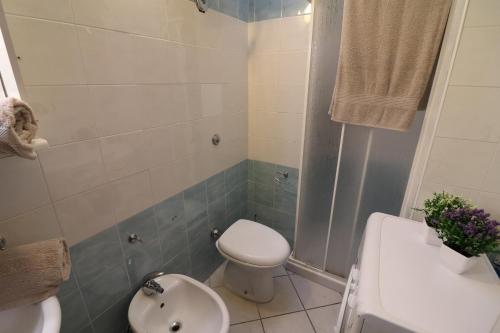 a bathroom with a toilet and a sink and a shower at Casa vacanze Arianna in centro in Otranto