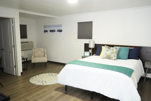 a bedroom with a large bed and a chair at North Idaho Inn in Coeur d'Alene