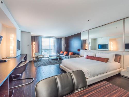 a hotel room with a bed and a desk and chairs at Beautiful High Rise Condo-307 in Las Vegas