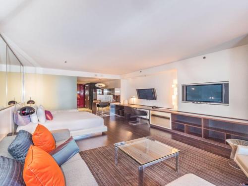 a living room with a couch and a tv at Beautiful High Rise Condo-307 in Las Vegas