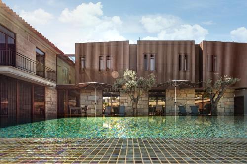 an external view of a building with a swimming pool at Quinta do Aido - WineTourism in Cinfães