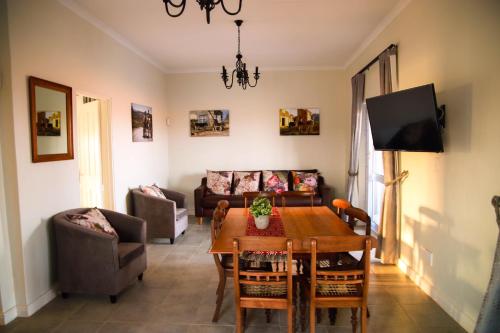 a living room with a table and a couch at Donkieshoek Accommodation & Campsite, Calvinia in Calvinia