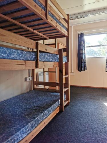 two bunk beds in a room with a window at X Adventure in Horsford