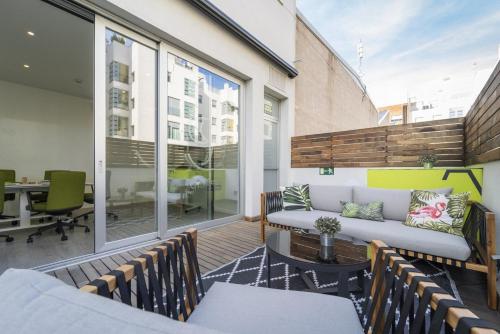 an apartment patio with a couch and a table at ARTIEM Madrid in Madrid