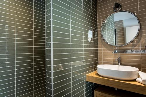 a bathroom with a sink and a mirror at Hôtel L'Ouvrée in Savigny-lès-Beaune