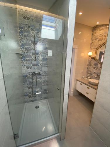 a shower with a glass door in a bathroom at Top villa with extraordinary view of Atlantic in São Martinho do Porto