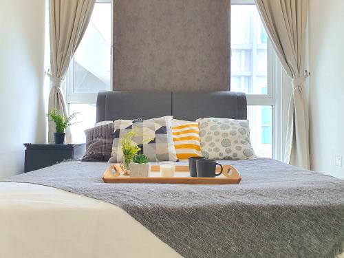 a tray of food on top of a bed at Kuala Lumpur Central Residences by BeeStay Management in Kuala Lumpur