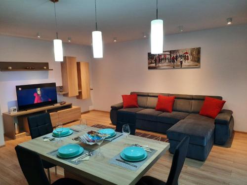 a living room with a table and a couch at Sorin`s Comfortable Apartment in Braşov