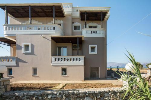 a large house with balconies on the side of it at Vasso Apartments 3 in Kissamos