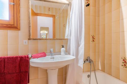 a bathroom with a sink and a mirror at Son Homs in Colònia de Sant Jordi
