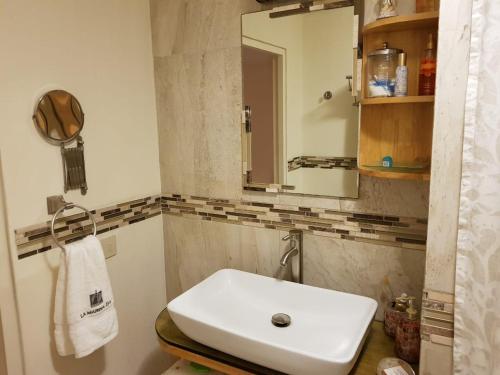 a bathroom with a white sink and a mirror at departamento de lujo, Puerto Vallarta. Mexico in Puerto Vallarta