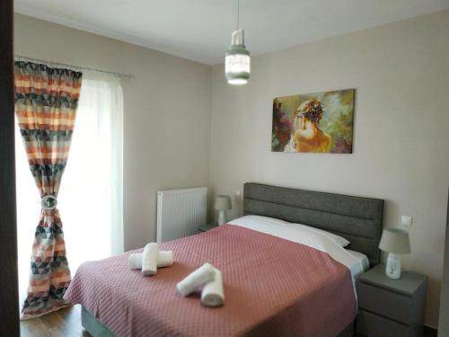 a bedroom with a bed with two towels on it at Meteora Rocks Apartment 1 in Kalabaka