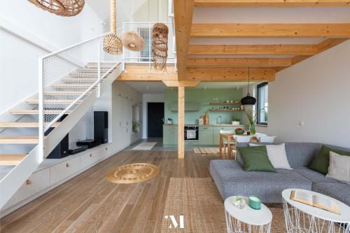a living room with a couch and a staircase at Punkt Mazury in Sędki