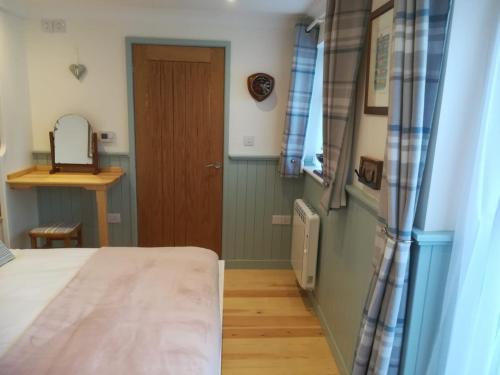 a bedroom with a bed and a wooden door at Sea Breeze in Freshwater