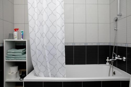 a bathroom with a shower curtain and a bath tub at Apartment Nika, Arena Zagreb in Zagreb